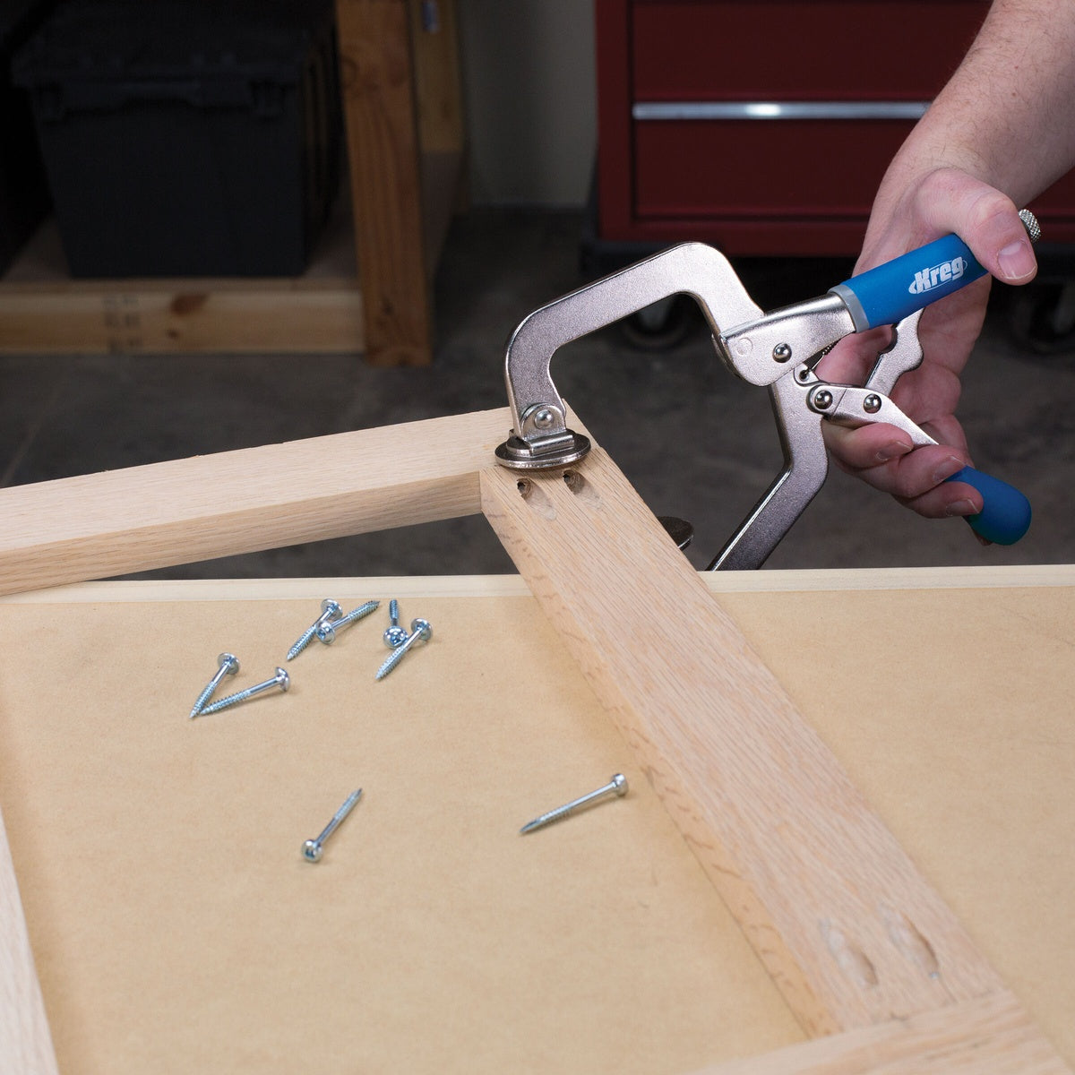 Kreg Tool KHC-PREMIUM Classic 3 Inch Face Clamp being positioned on a face frame assembly during woodworking bench work