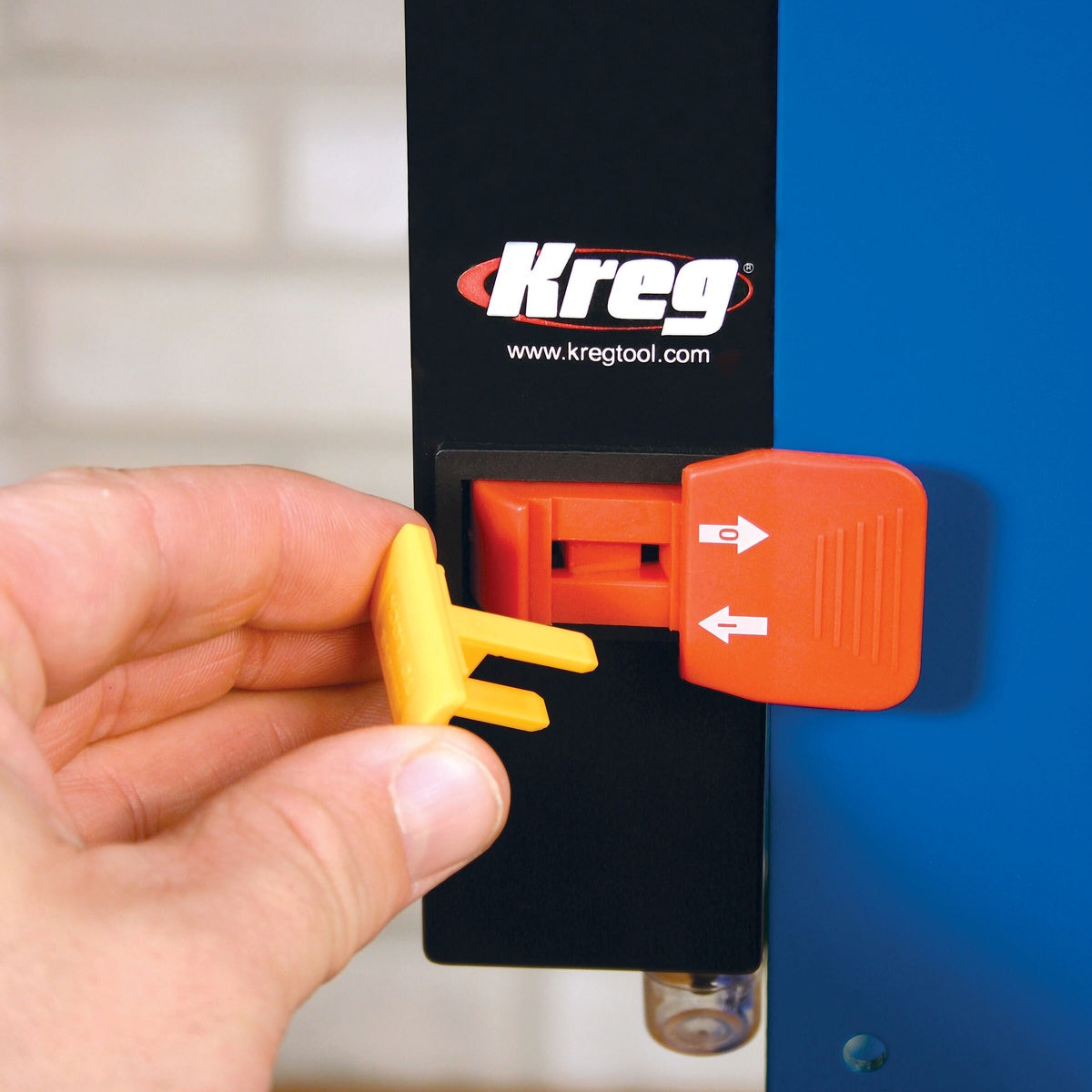 Kreg PRS3100 Multi-Purpose Router Table Switch mounted on a router table frame with Key-Lok safety insert being removed during shop setup
