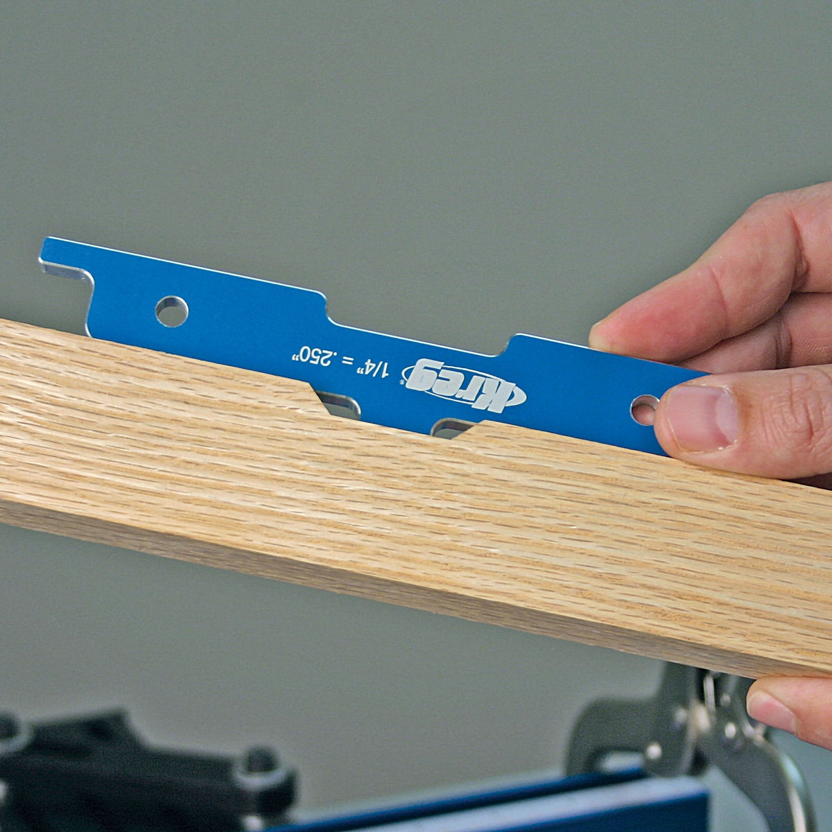 Kreg PRS3400 Precision Router Table Setup Bars checking groove depth on a wood workpiece in a woodworking shop