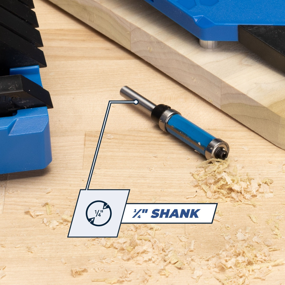 Kreg Tool PRS250 Flush-Trim Bit, 1/4 in. Shank next to wood shavings on a workbench for woodworking and laminate trimming tasks