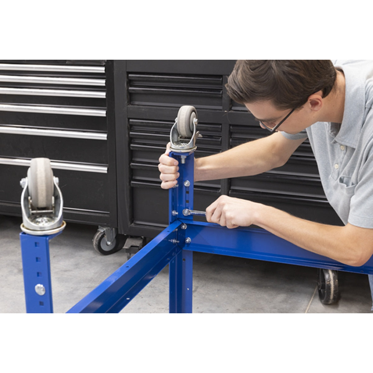 Kreg Universal Bench with Hardwood Top 24 x 32 with Dog Holes frame being adjusted for bench height in a workshop