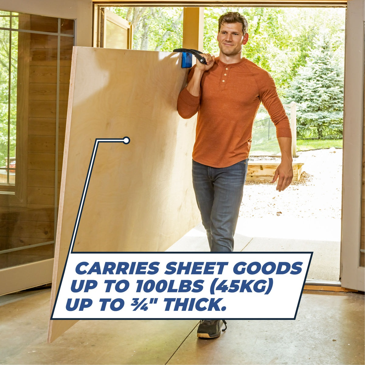 Kreg KMA3000 Panel Carrier carrying a full plywood sheet through a doorway during interior project material handling