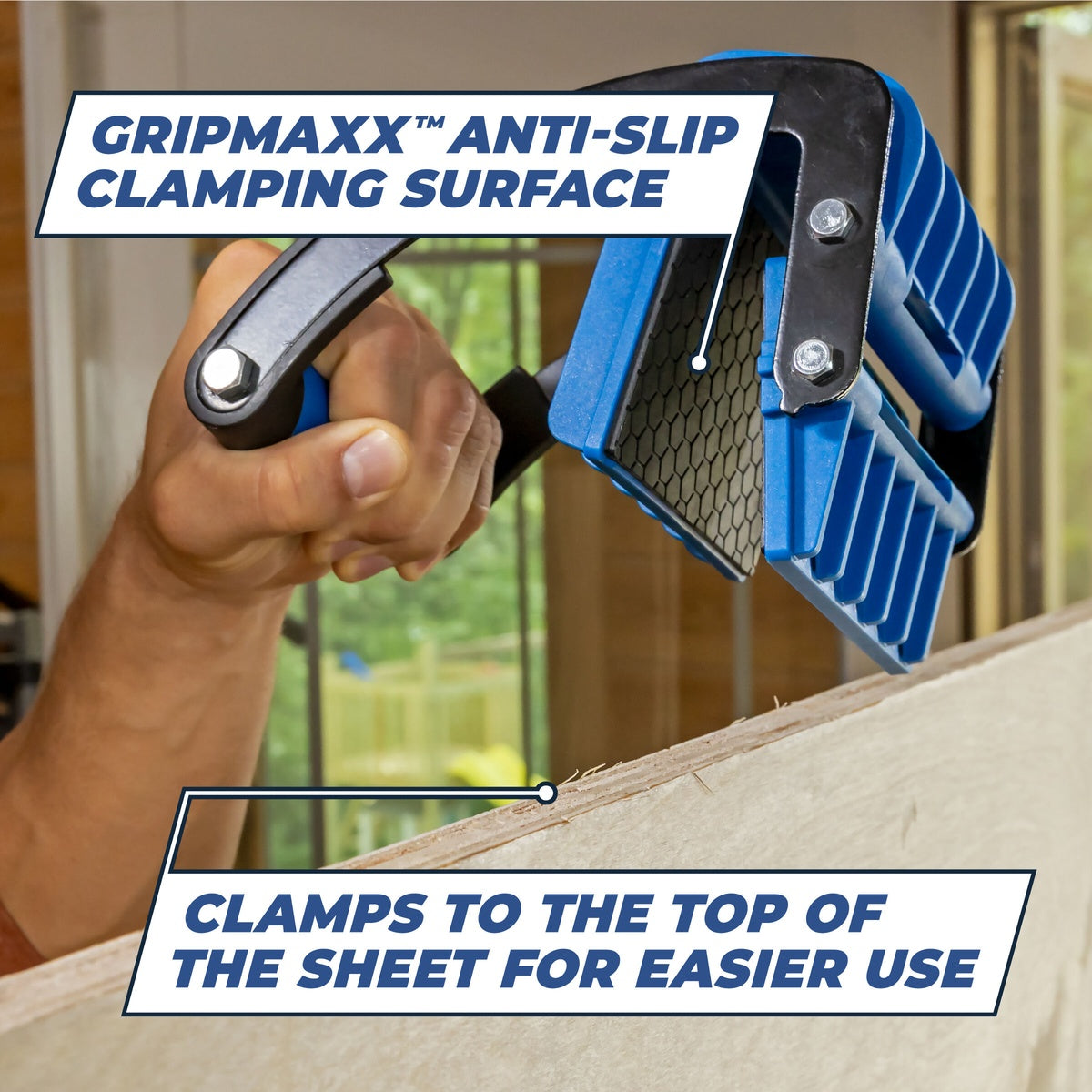 Kreg KMA3000 Panel Carrier clamped to the top edge of plywood with anti-slip pads for secure sheet handling