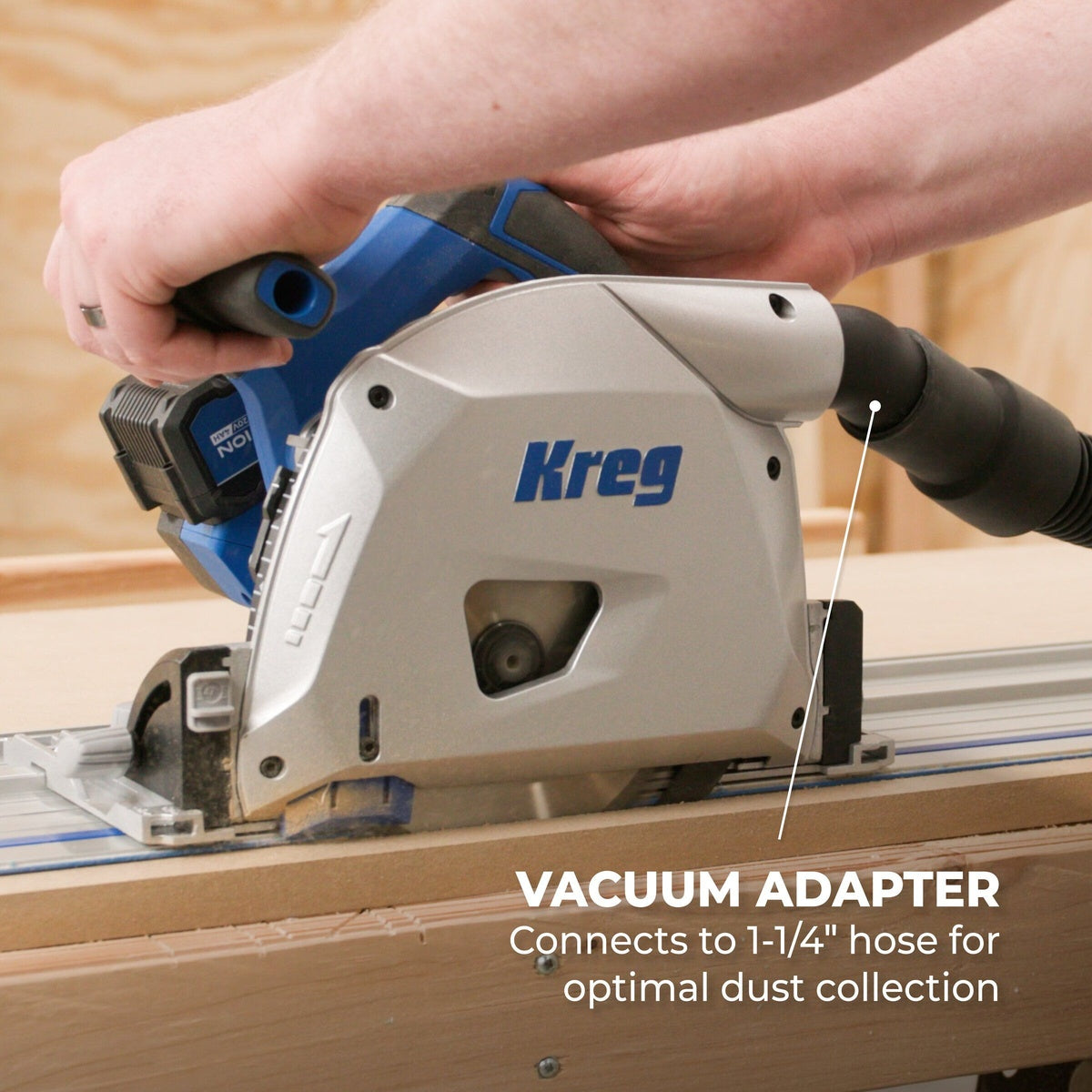 Kreg 20V Ionic Drive 6 1/2 inch Plunge-Cut Track Saw Kit connected to dust extraction while making a guided cut in sheet material