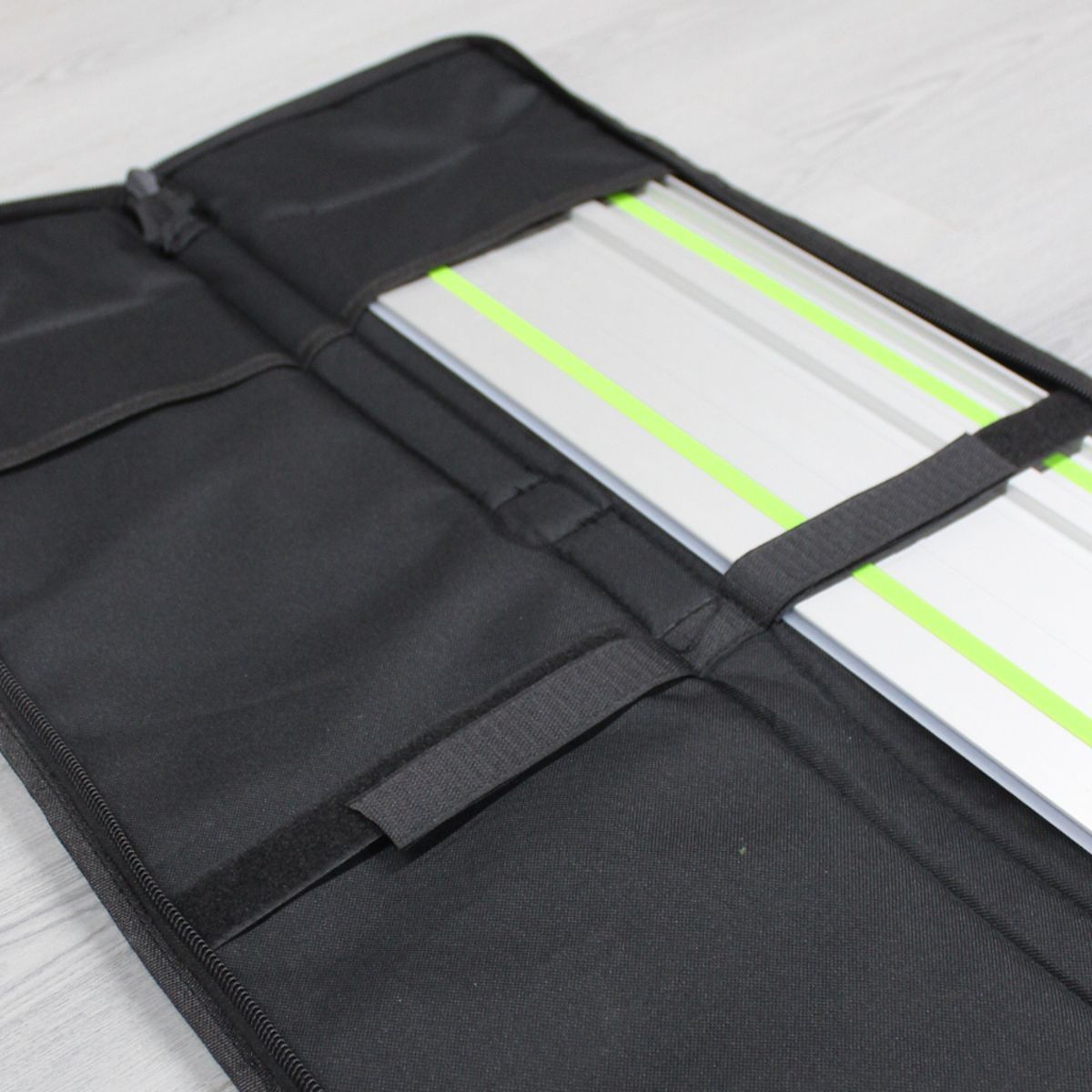 Byrne Guide Rail Bag 1400mm open with a green guide rail resting in the padded nylon compartment