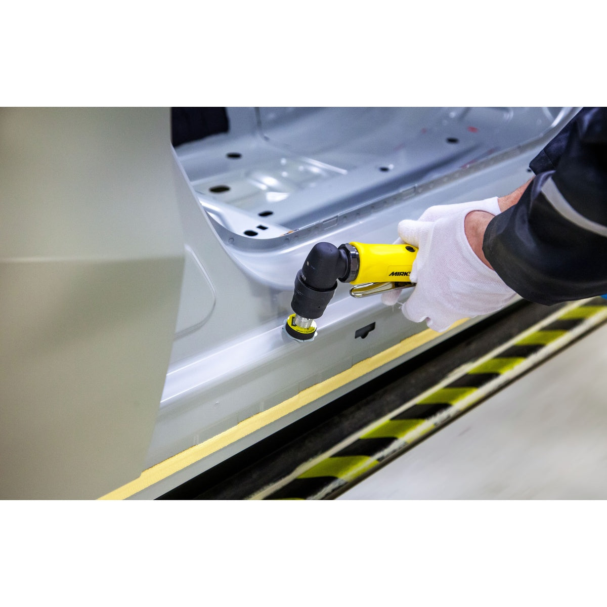 Mirka AOS angled orbital sander in use on automotive panel