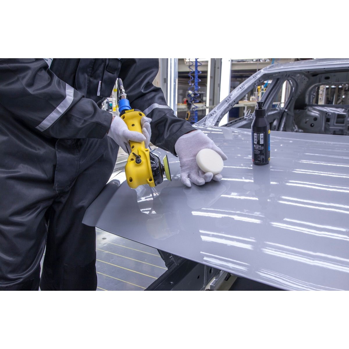 Mirka two-handed orbital polisher in automotive finishing application