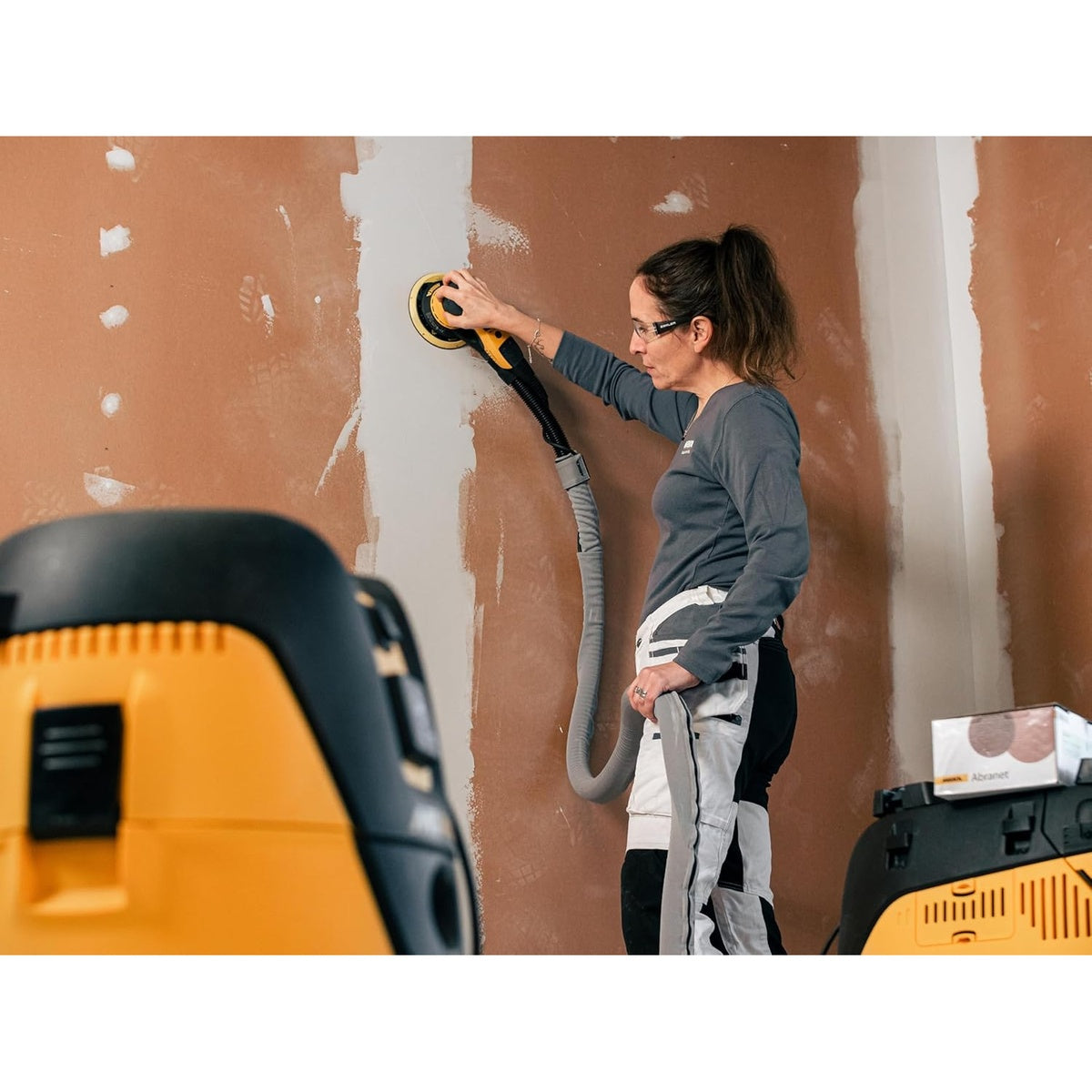 Mirka DEROS drywall sanding application with dust extraction hose
