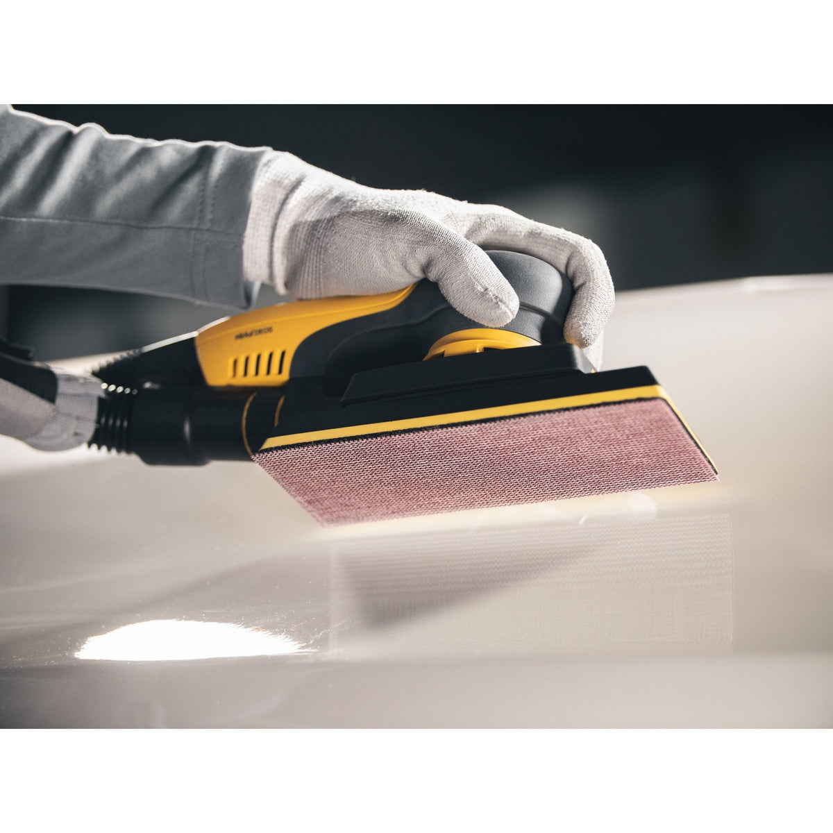 Abranet mesh sanding sheet attached to a rectangular hand sander