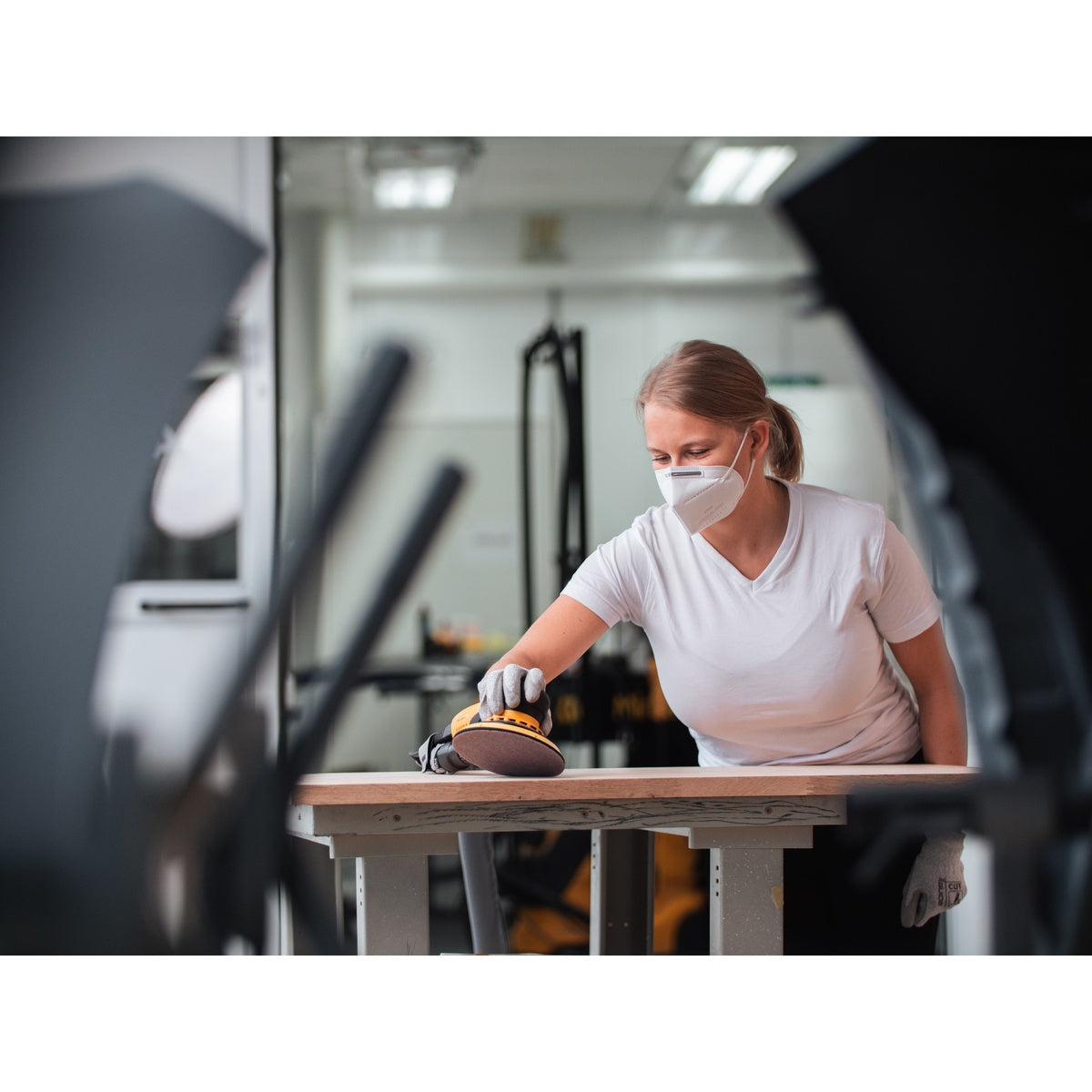 Mirka Abranet sanding disc in use on a wood panel with an orbital sander