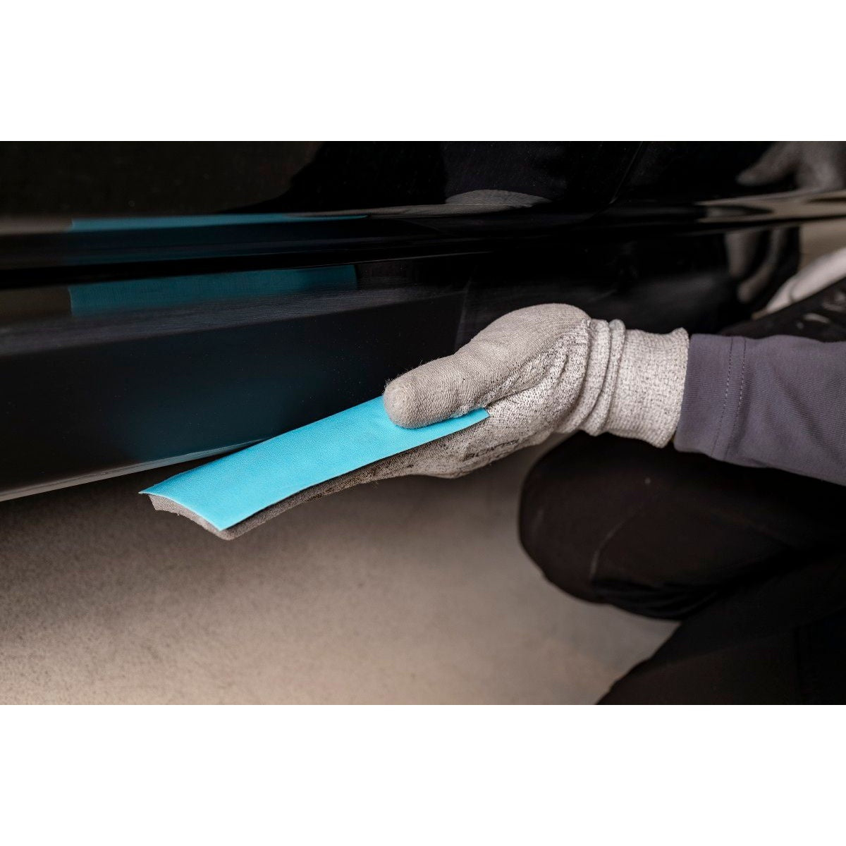 Mirka Novastar Flex hand sanding sheet folded around a sanding pad for detail sanding