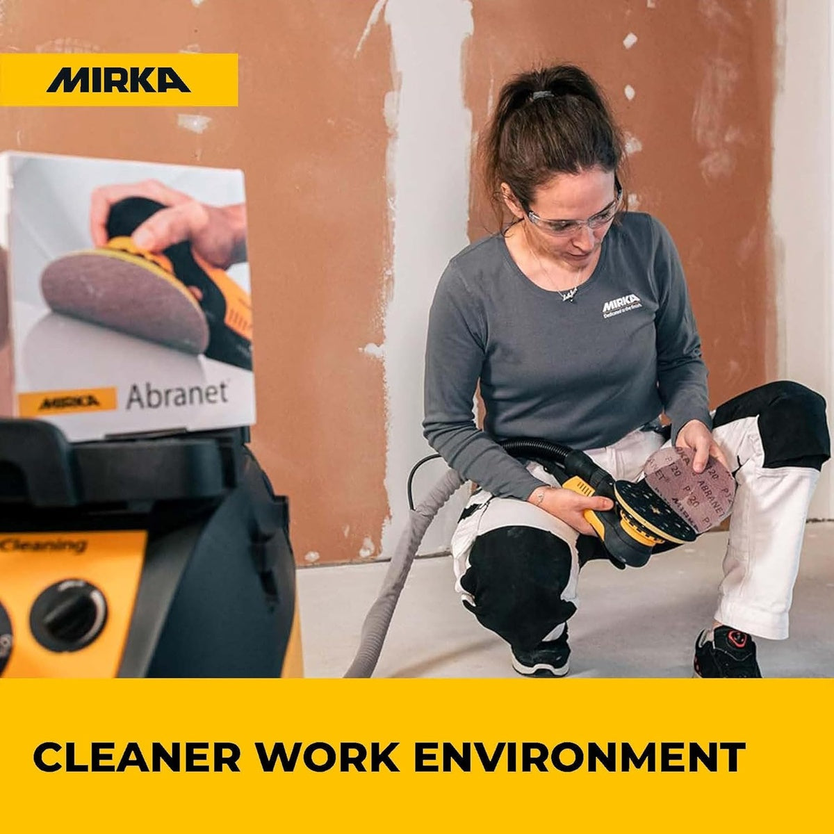 Person using a Mirka orbital sander with Abranet sanding discs in a dust-controlled workspace