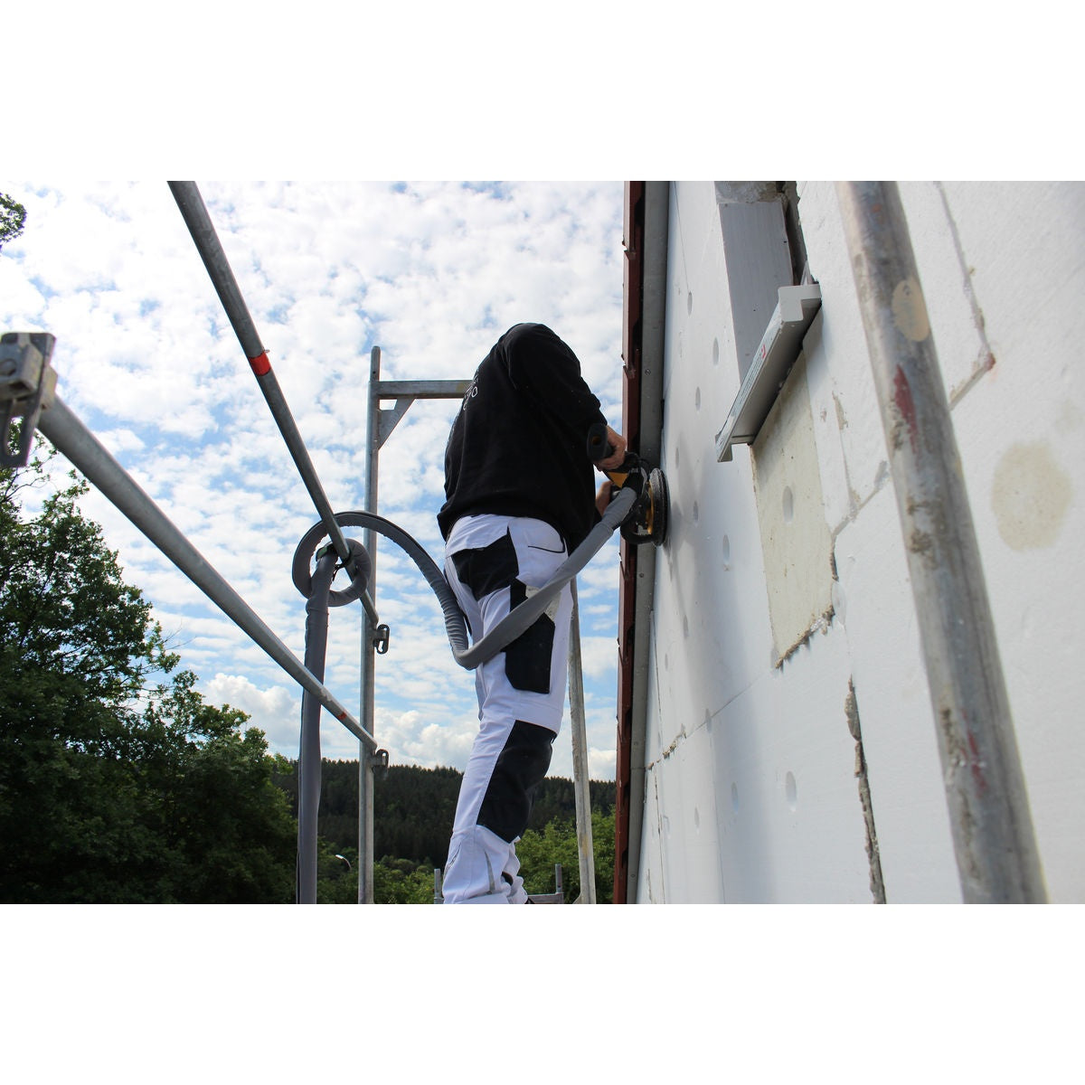 Mirka Styro sanding disc in use on exterior insulation wall