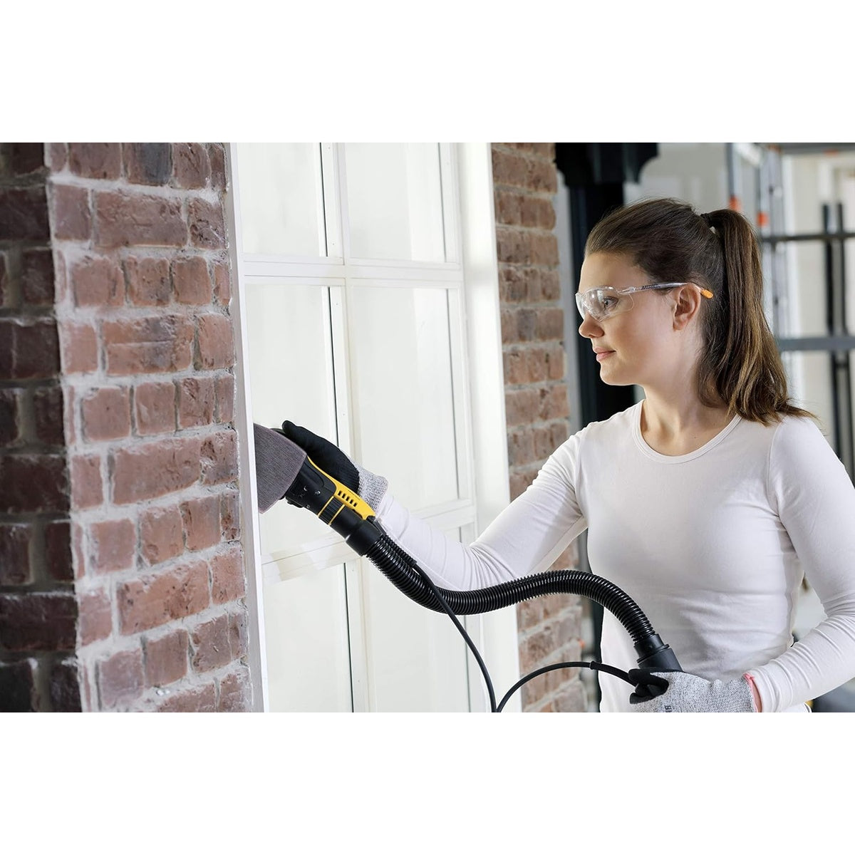 Mirka delta sander using Abranet mesh sanding sheet on trim with dust extraction hose