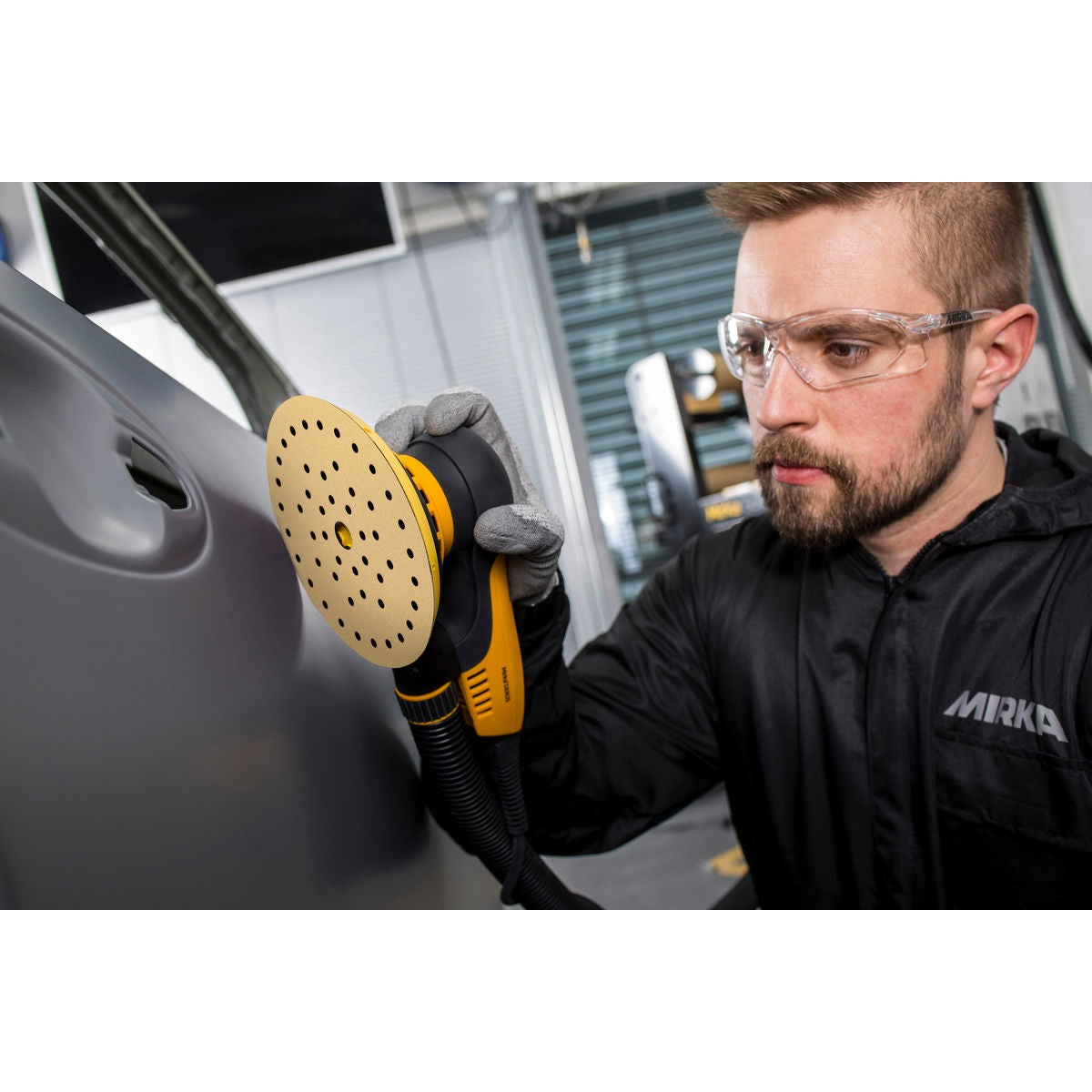 Mirka Gold Multifit hook and loop sanding disc mounted on an orbital sander