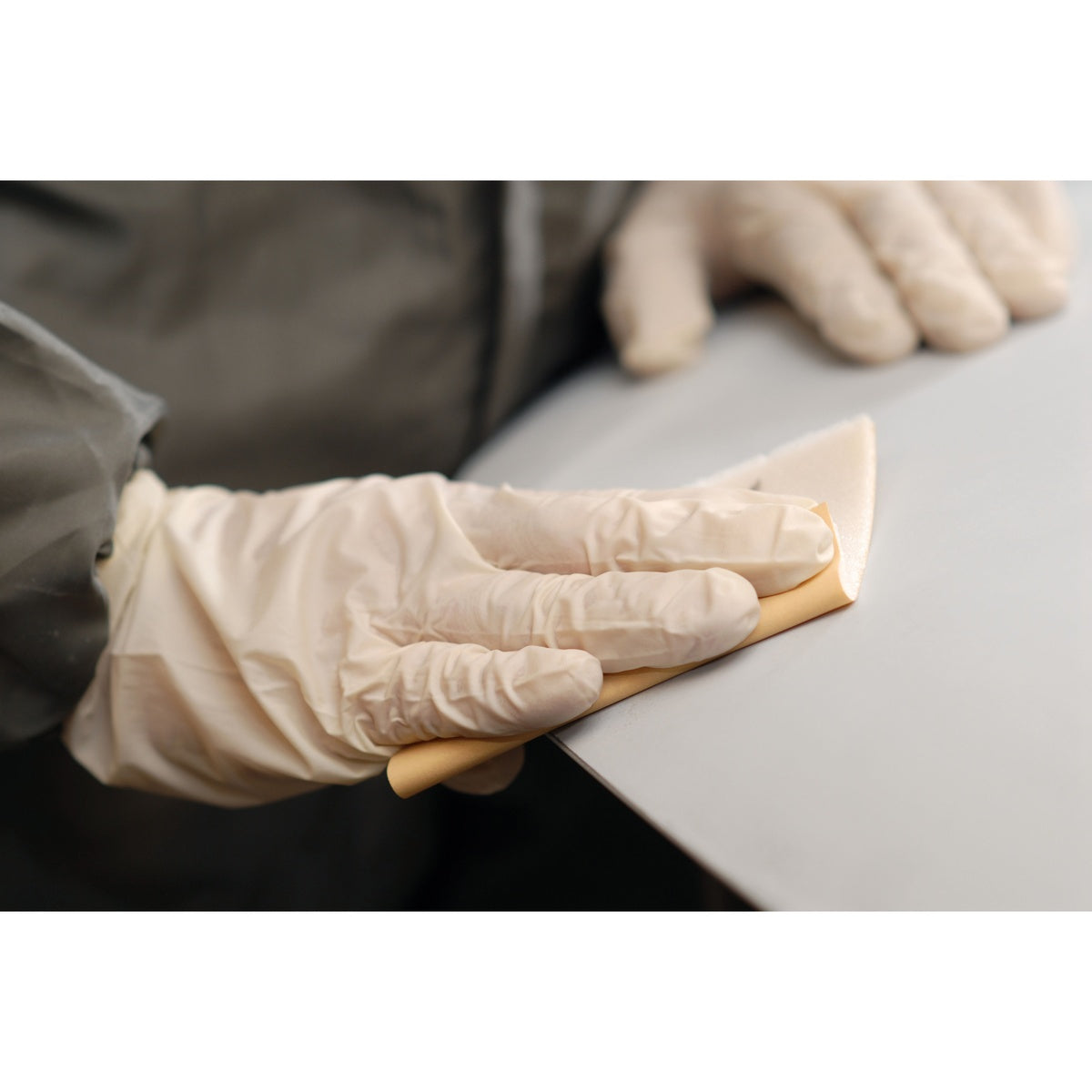 Close-up of Mirka Goldflex Soft sheet being used for hand sanding