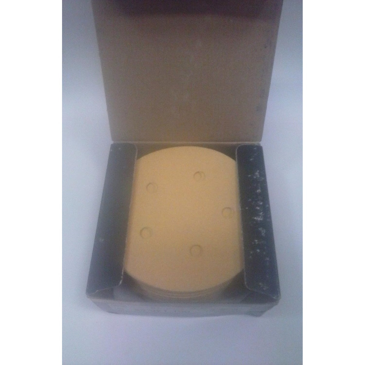 Open box of Mirka 5-hole PSA sanding discs