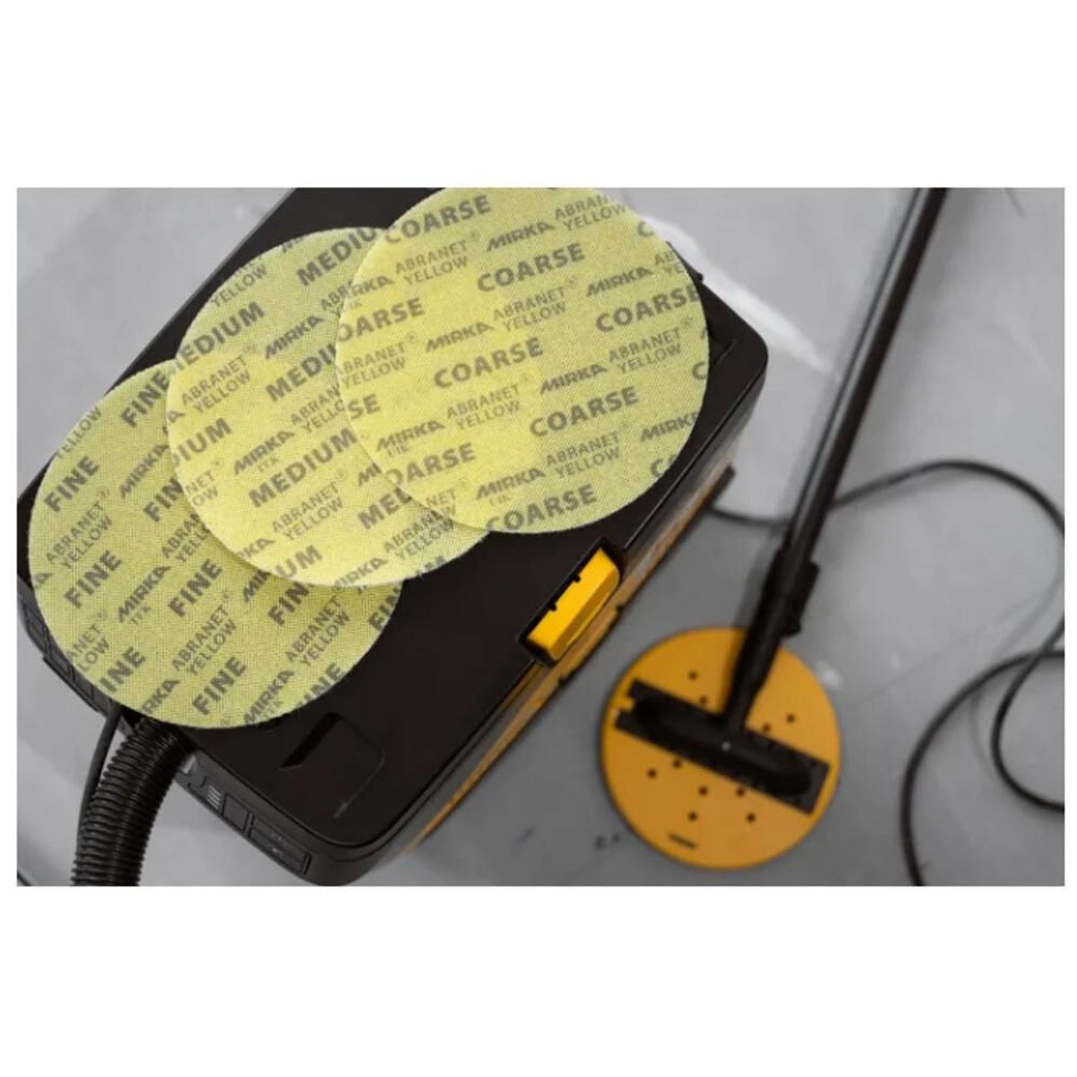 Mirka Abranet Yellow sanding discs in fine, medium, and coarse grades with wall sander