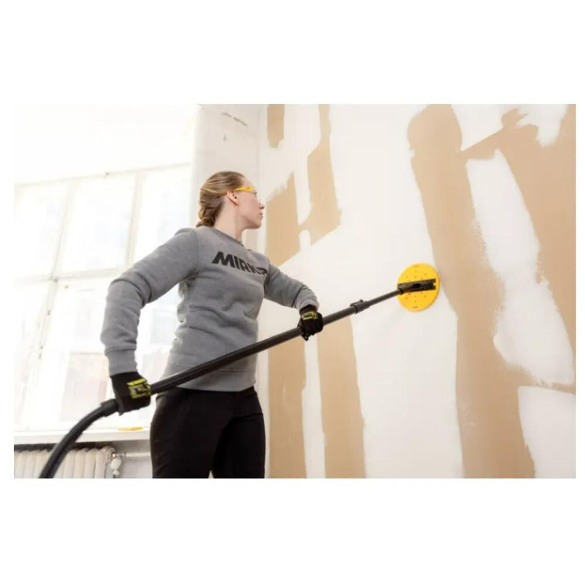 Mirka long-neck wall sander using Abranet Yellow disc on drywall