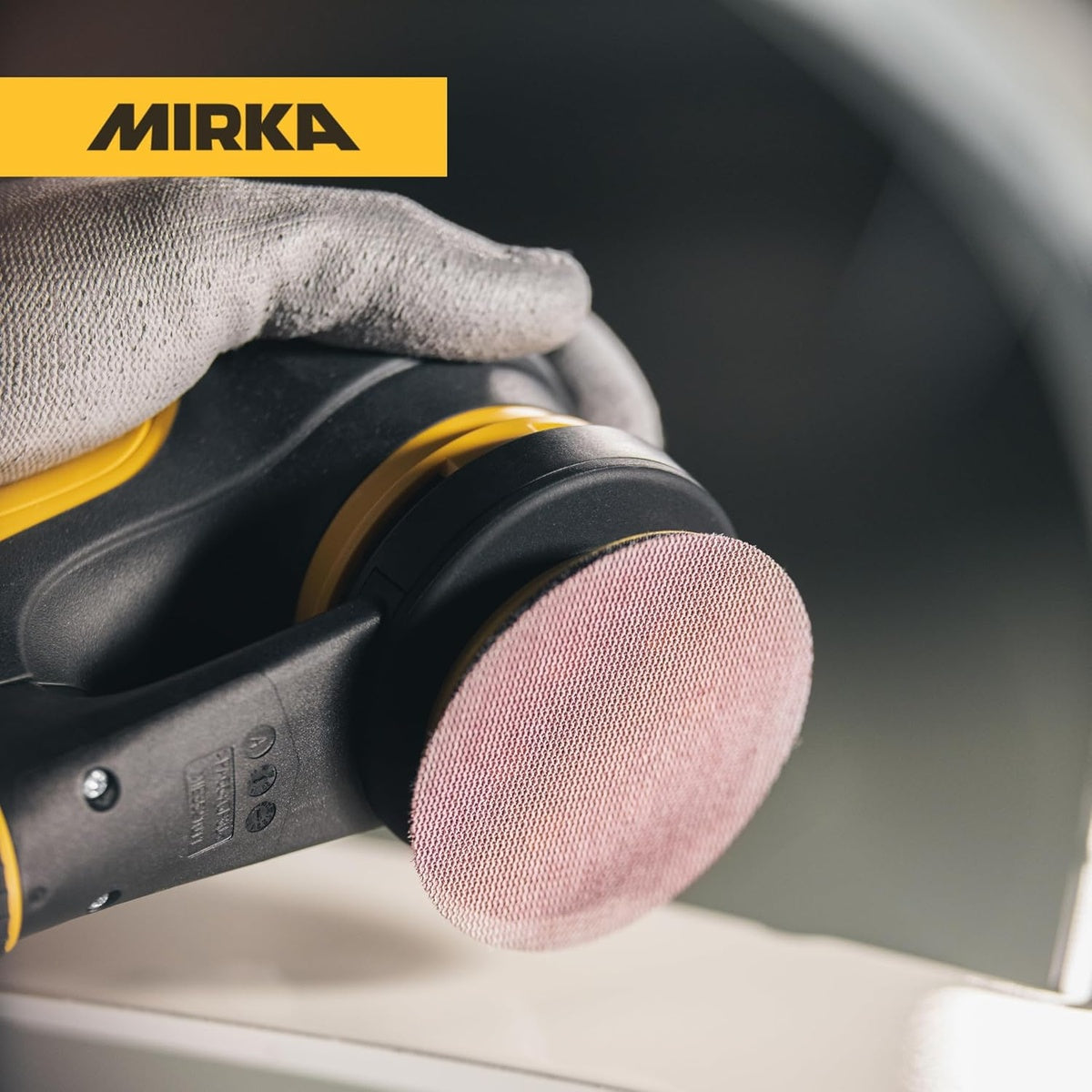 Mirka Abranet 3-in. mesh sanding disc on orbital sander close-up