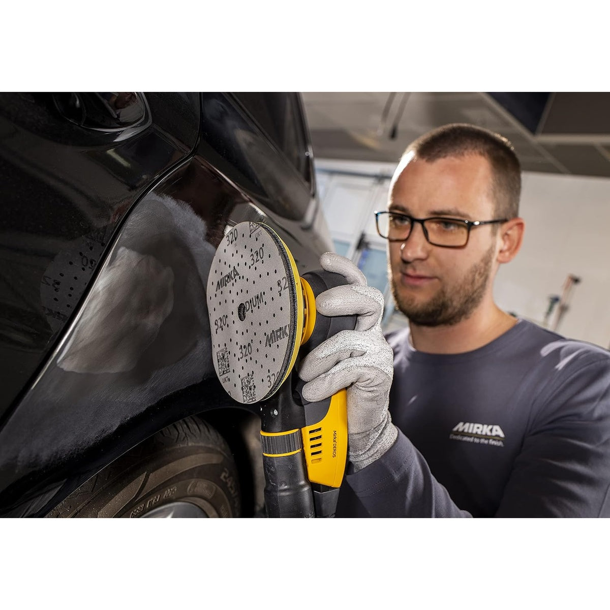 Mirka orbital sander using an Iridium sanding disc on an automotive body panel