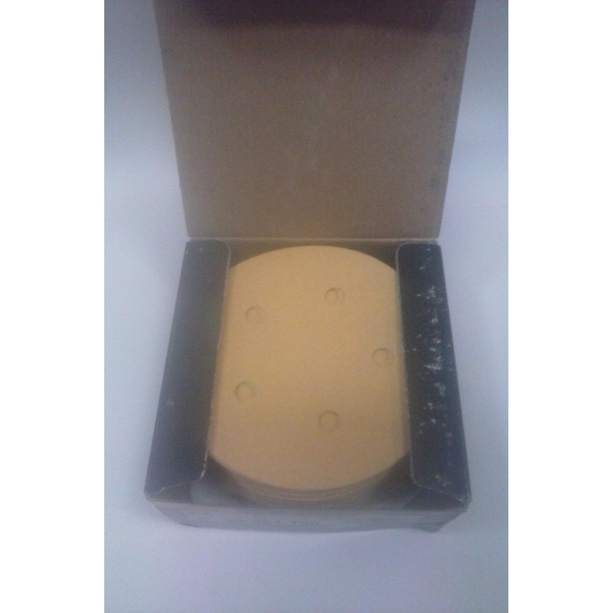 Open box of Mirka Bulldog Gold 5-in. 5-hole sanding discs