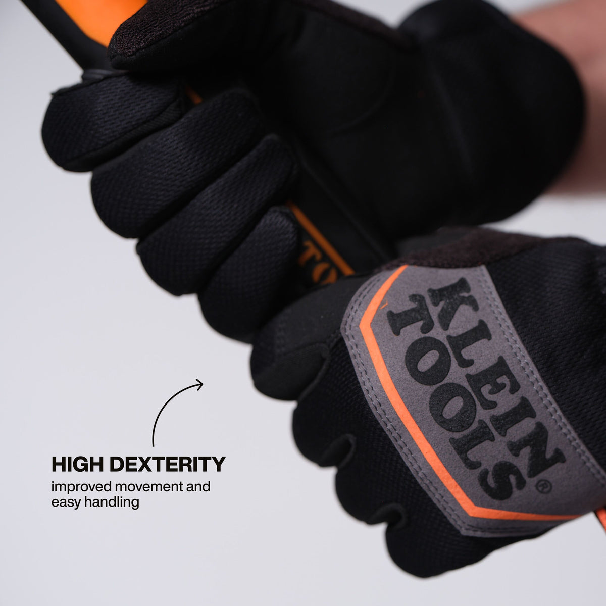 Klein Tools 22020 medium gloves touchscreen compatible fingertips operating a smartphone on the jobsite
