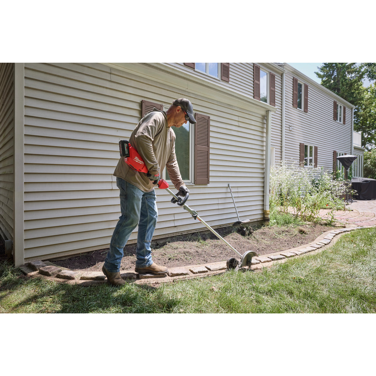 Milwaukee M18 QUIK-LOK Brushless 15-in. String Trimmer 6.0Ah Kit 3115-21ST in use outdoors