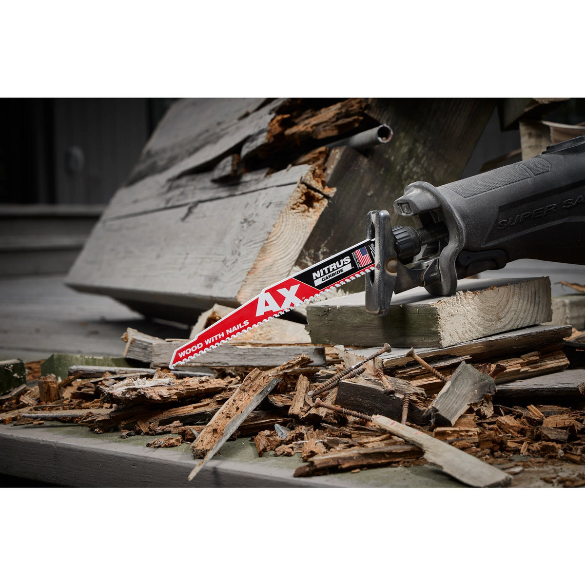 Milwaukee 48-00-7252 9-inch AX NITRUS carbide SAWZALL blade cutting through nail-filled demolition lumber in a reciprocating saw on a remodel jobsite