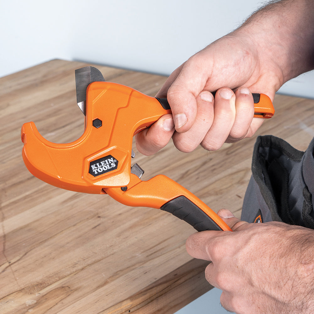 Klein 1-1/4-in. Ratcheting PVC Pipe Cutter (50063) in use on a jobsite