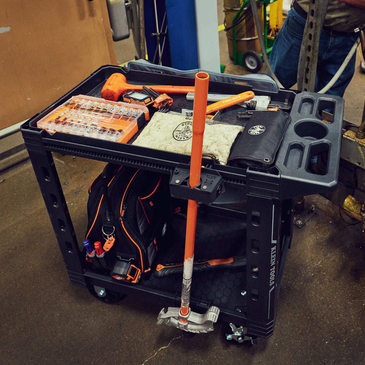 Klein MODbox utility cart with conduit bender holder in use on a jobsite