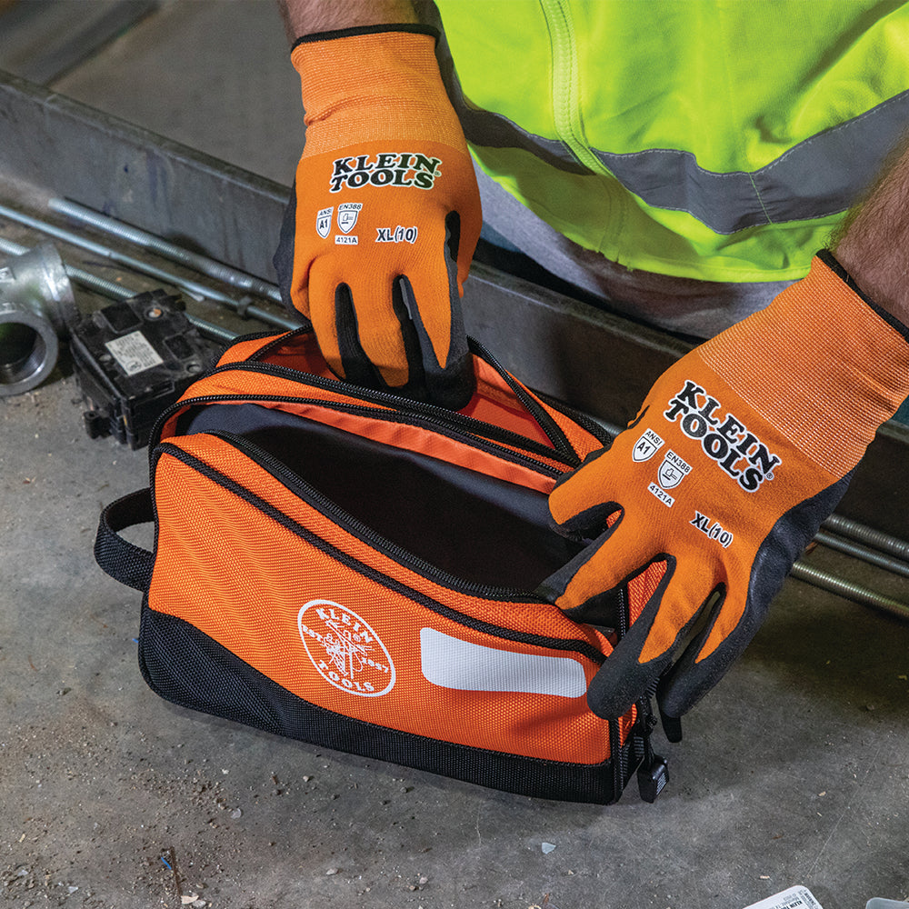 Klein orange double zipper bag in use on a jobsite