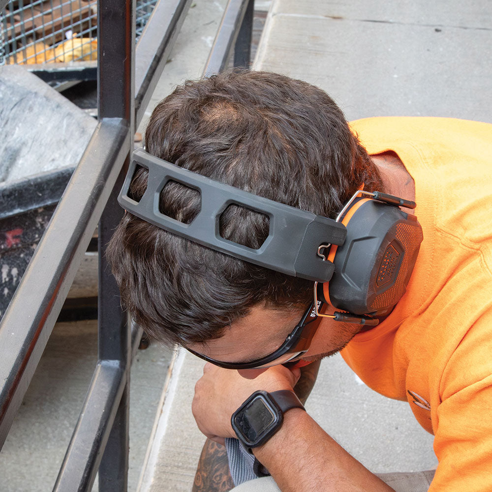 Klein slim ear muffs worn with a cap