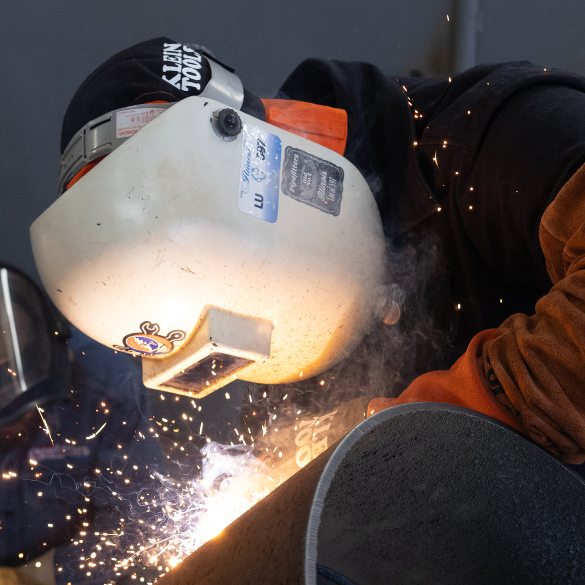 Klein flame-resistant welding cap worn while welding