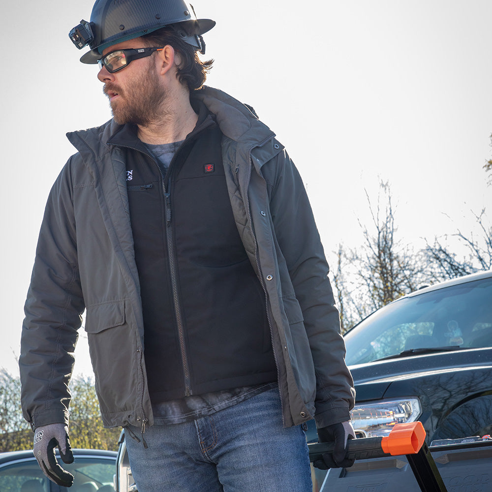 Klein heated base layer vest worn under a jacket on the jobsite