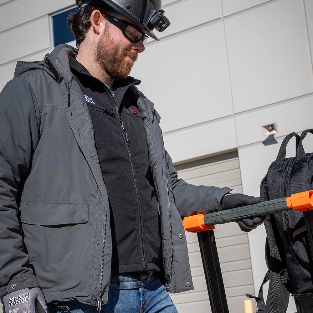 Klein heated base layer vest worn on a cold-weather jobsite