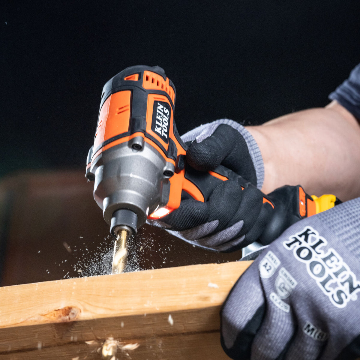 Klein Tools 65304KNECT pass-through socket on an impact driver fastening a nut on threaded rod overhead