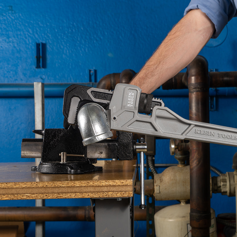 Klein 18-in. cast aluminum pipe wrench gripping a pipe fitting