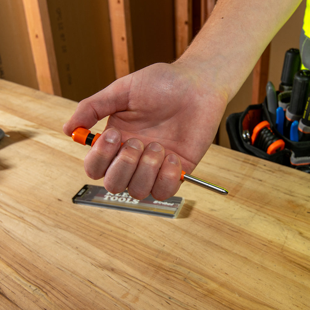 Klein Tools Skribes mechanical marking tool marking inside a deep hole with extended needle nose