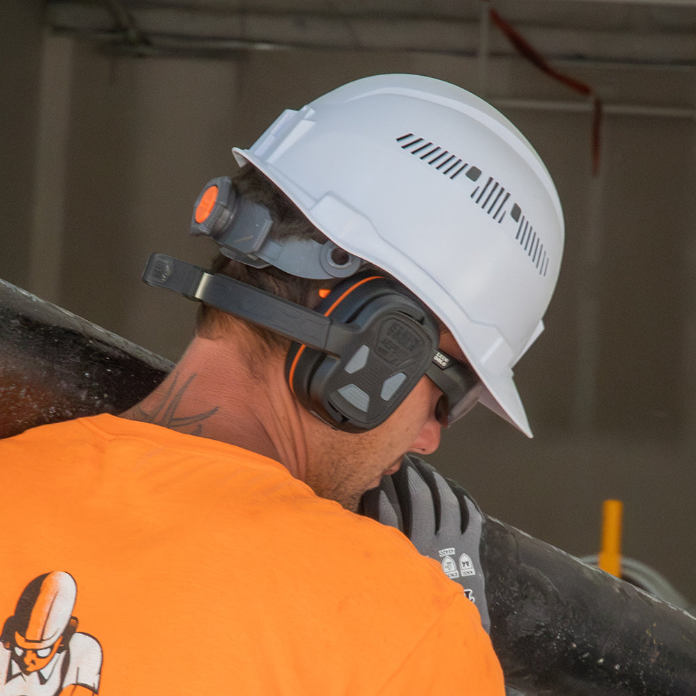 Klein behind-the-head earmuffs worn with a cap