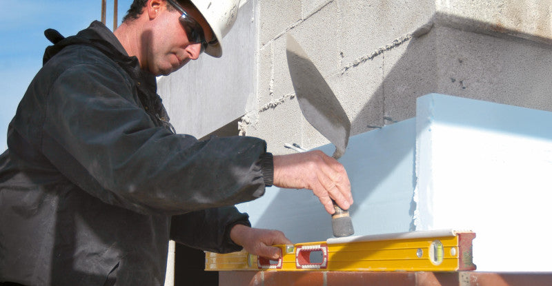 Stabila Type 196-2 K mason level in use on a brick wall