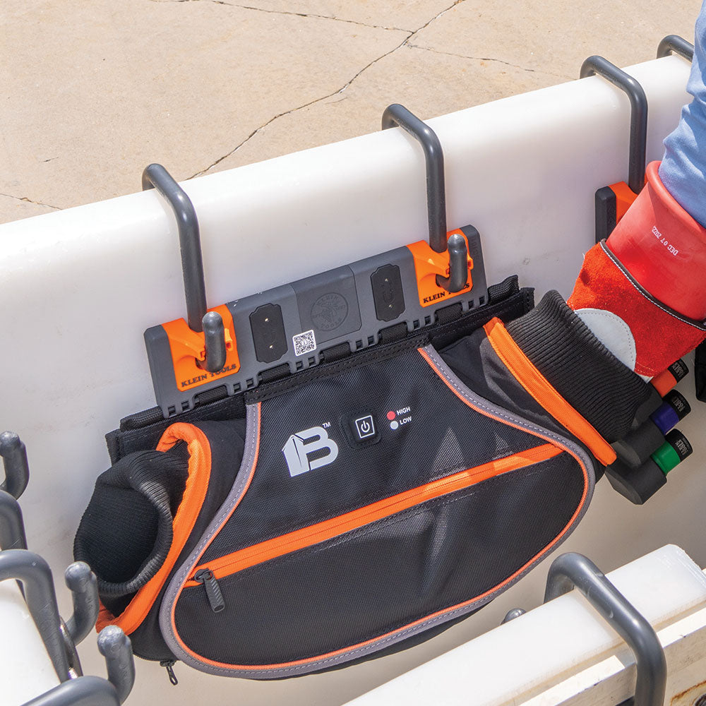 Lineman warming hands in the Klein hand warmer module