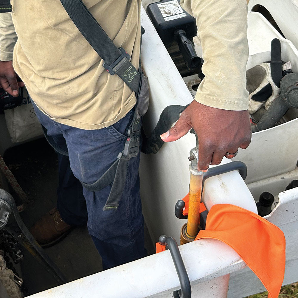 Klein Hot Stick Holder hung on an aerial bucket holding a hot stick
