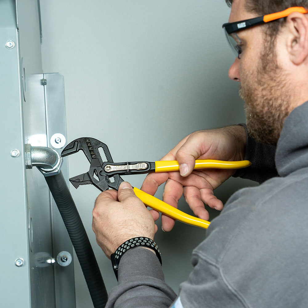 Klein plier wrench gripping pipe