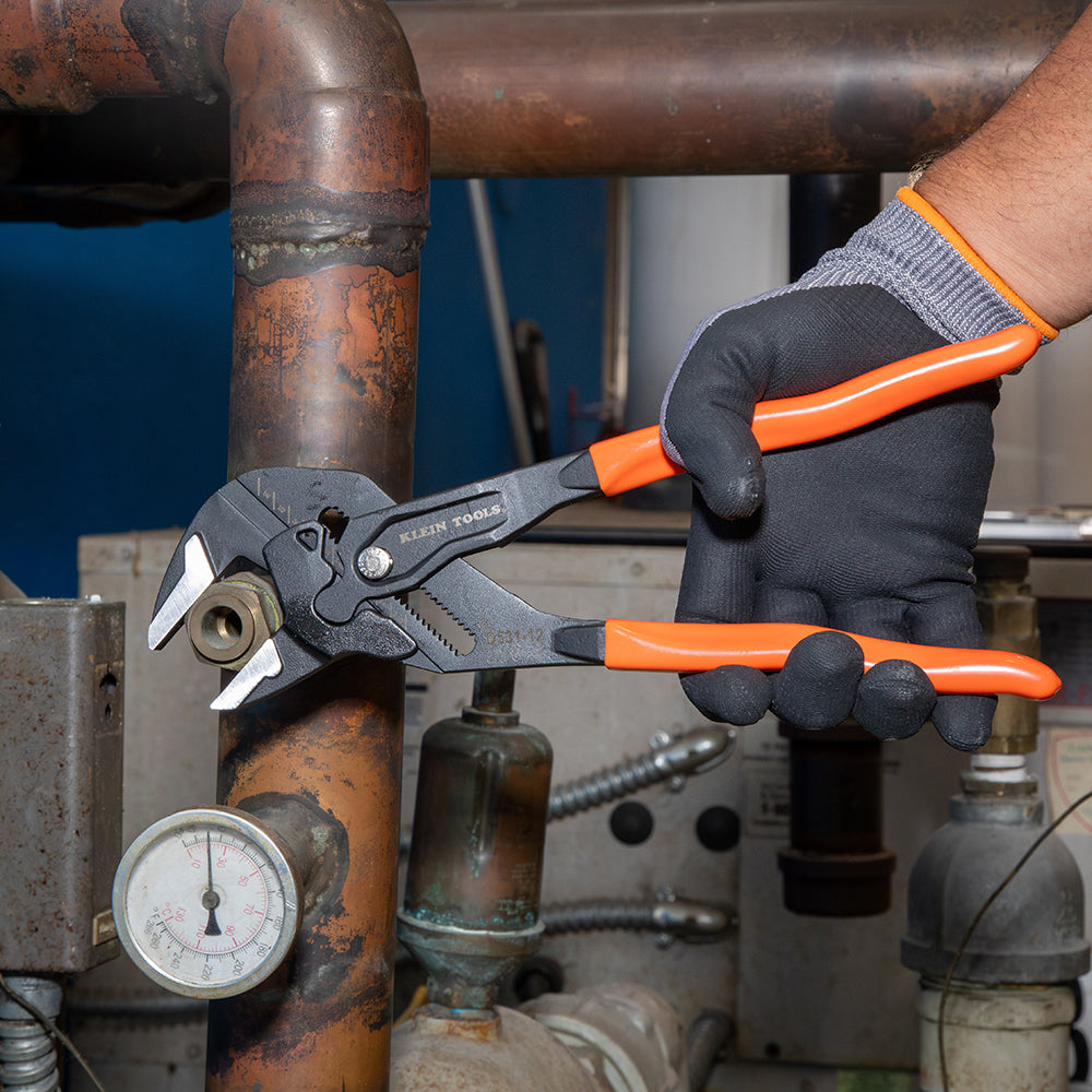 Klein compact plier wrench tightening a nut