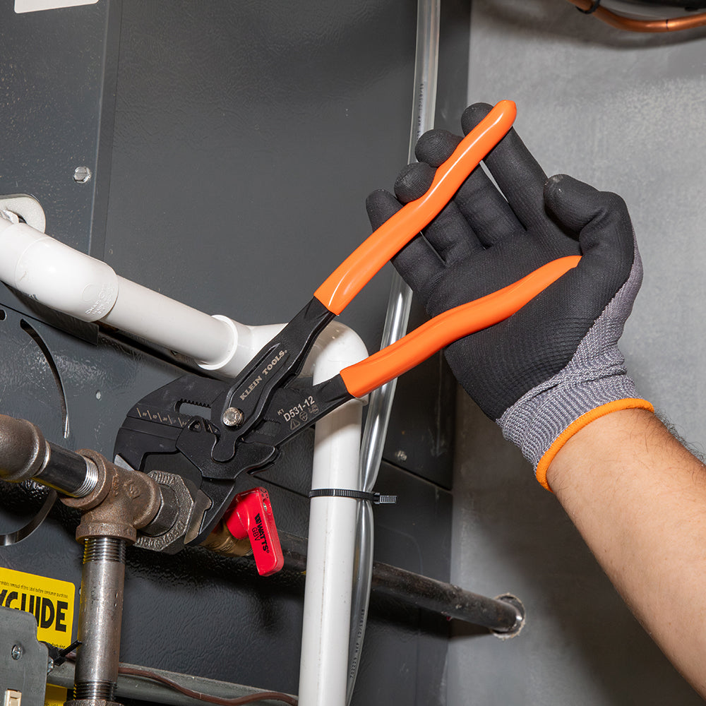 Klein compact plier wrench holding a pipe
