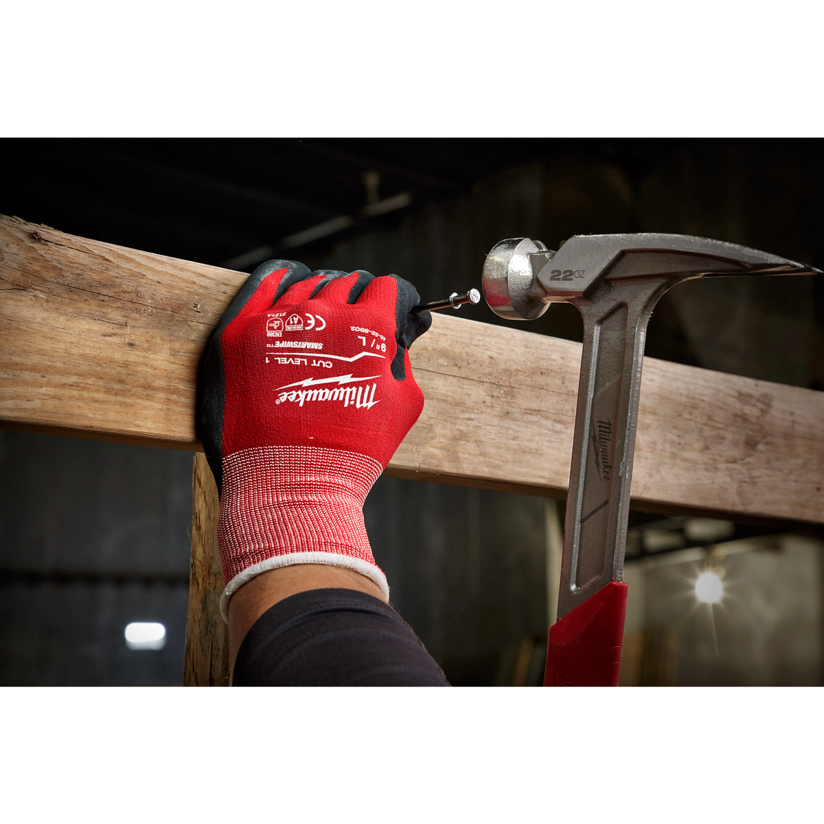 Milwaukee Cut Level 1 Nitrile Dipped Gloves holding a wood plank on a jobsite