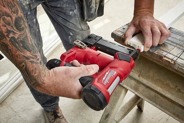 Professional using Milwaukee 2540 23 Gauge Pin Nailer on construction